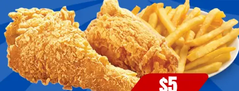 Two pieces of fried chicken with fries